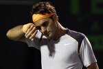 KEY BISCAYNE, FL - APRIL 01:  Roger Federer of Switzerland wipes sweat off of his forehead against Rafael Nadal of Spain during their men's semifinal match at the Sony Ericsson Open at Crandon Park Tennis Center on April 1, 2011 in Key Biscayne, Florida.  (Photo by Clive Brunskill/Getty Images)