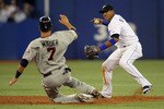 TORONTO,CANADA - APRIL 1:  Yunel Escobar #5 of the Toronto Blue Jays turns a double play as Joe Mauer #7 of the Minnesota Twins slides into 2nd base on opening day during their MLB game at the Rogers Centre April 1, 2011 in Toronto, Ontario, Canada.(Photo By Dave Sandford/Getty Images)