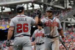 WASHINGTON, DC - APRIL 03: Martin Prado #14 of the Atlanta Braves (R) is congratulated by teammate Dan Uggla #26 after scoring against the Washington Nationals during the seventh inning at Nationals Park on April 3, 2011 in Washington, DC.  (Photo by Rob Carr/Getty Images)