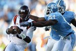 CHAPEL HILL, NC - NOVEMBER 13:  Tyrod Taylor #5 of the Virginia Tech Hokies is tackled by Bruce Carter #54 and teammate Jared McAdoo #97 of the North Carolina Tar Heels during their game at Kenan Stadium on November 13, 2010 in Chapel Hill, North Carolina.  (Photo by Streeter Lecka/Getty Images)