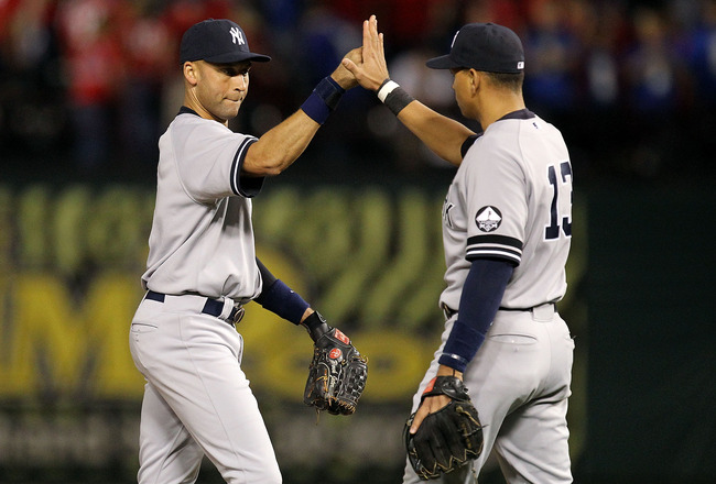 ARLINGTON, TX - OCTOBER 15:  (L-R) Derek Jeter #2 and Alex Rodriguez #13 of the New York Yankees celebrate after the Yankees won 6-5 against the Texas Rangers in Game One of the ALCS during the 2010 MLB Playoffs at Rangers Ballpark in Arlington on October 15, 2010 in Arlington, Texas.  (Photo by Ronald Martinez/Getty Images)