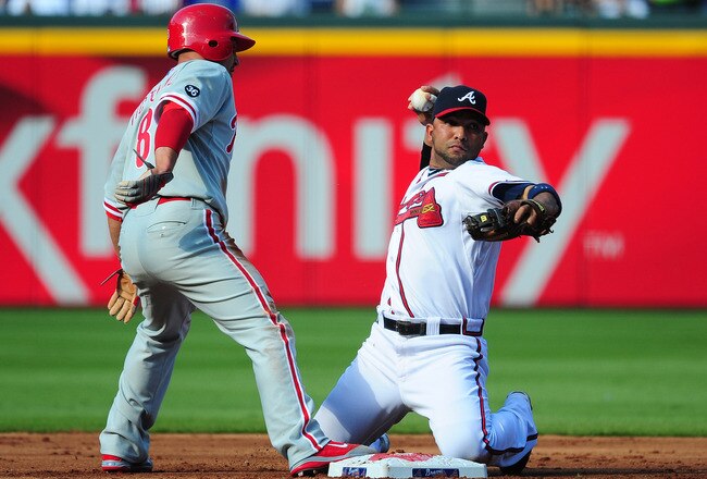 ATLANTA - OCTOBER 2: Alex Gonzalez #2 the Atlanta Braves attempts to turn a double play against Shane Victorino #8 of the Philadelphia Phillies at Turner Field on October 2, 2010 in Atlanta, Georgia.  (Photo by Scott Cunningham/Getty Images)