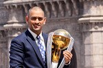 MUMBAI, INDIA - APRIL 03:  India's cricket team captain Mahendra Singh Dhoni poses with the  ICC Cricket World Cup Trophy, with the Gateway of India in the backdrop, during a photo call at the Taj Palace Hotel on April 3, 2011 in Mumbai, India.  (Photo by Ritam Banerjee/Getty Images)