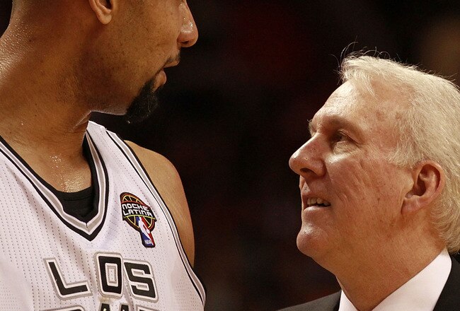 MIAMI - MARCH 14:  Center Tim Duncan #21 of the San Antonio Spurs chats with his Coach Greg Popovich against the Miami Heat at American Airlines Arena on March 14, 2011 in Miami, Florida. NOTE TO USER: User expressly acknowledges and agrees that, by downloading and/or using this Photograph, User is consenting to the terms and conditions of the Getty Images License Agreement.  (Photo by Marc Serota/Getty Images)