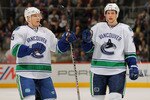 DENVER, CO - JANUARY 18:  Christian Ehrhoff #5 and Alexander Edler #23 of the Vancouver Canucks celebrate a goal against the Colorado Avalanche at the Pepsi Center on January 18, 2011 in Denver, Colorado. The Avalanche defeated the Canucks 4-3 in overtime.  (Photo by Doug Pensinger/Getty Images)