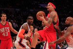 NEW YORK, NY - MARCH 30:  Deron Williams #8 of the New Jersey Nets drives against Anthony Carter#25 of the New York Knicks at Madison Square Garden on March 30, 2011 in New York City. NOTE TO USER: User expressly acknowledges and agrees that, by downloading and/or using this Photograph, User is consenting to the terms and conditions of the Getty Images License Agreement. The Knicks defeated the Nets 120-116.  (Photo by Chris Trotman/Getty Images)