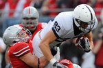COLUMBUS, OH - NOVEMBER 13:  Brett Brackett #83 of the Penn State Nittany Lions is tackled by Ross Homan #51 of the Ohio State Buckeyes and Aaron Gant #8 of the Ohio State Buckeyes after making a pass reception at Ohio Stadium on November 13, 2010 in Columbus, Ohio.  (Photo by Jamie Sabau/Getty Images)