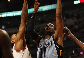 CHICAGO, IL - MARCH 25: Mike Conley #11 of the Memphis Girzzlies puts up a shot over Derrick Rose #1 of the Chicago Bulls at the United Center on March 25, 2011 in Chicago, Illinois. NOTE TO USER: User expressly acknowledges and agrees that, by downloading and/or using this photograph, User is consenting to the terms and conditions of the Getty Images License Agreement. (Photo by Jonathan Daniel/Getty Images)