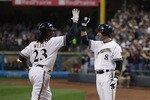 MILWAUKEE, WI - APRIL 04: Rickie Weeks #23 of the Milwaukee Brewers is congratulated by teammate Ryan Braun #8 after hitting a solo home run in the 3rd inning against the Atlanta Braves during the home opener at Miller Park on April 4, 2011 in Milwaukee, Wisconsin. (Photo by Jonathan Daniel/Getty Images)