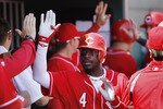 CINCINNATI, OH - APRIL 3: Brandon Phillips #4 of the Cincinnati Reds celebrates with teammates after hitting a three-run home run in the 4th inning against the Milwaukee Brewers at Great American Ball Park on April 3, 2011 in Cincinnati, Ohio. The Reds won 12-3. (Photo by Joe Robbins/Getty Images)