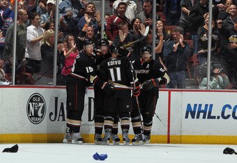 ANAHEIM, CA - APRIL 06:  (L-R) Ryan Getzlaf #15, Corey Perry #10, Saku Koivu #11 and Teemu Selanne #8 of the Anaheim Ducks celebrate Perry's third goal of the game and 50th of the year in the second period against the San Jose Sharks at Honda Center on April 6, 2011 in Anaheim, California.  (Photo by Jeff Gross/Getty Images)
