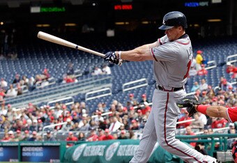 WASHINGTON, DC - APRIL 03: Catcher Ivan Rodriguez #7 of the Washington Nationals looks on a Chipper Jones #10 of the Atlanta Braves follows through on swing at Nationals Park on April 3, 2011 in Washington, DC.  (Photo by Rob Carr/Getty Images)