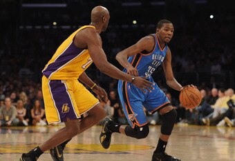 LOS ANGELES, CA - JANUARY 17:  Kevin Durant #35 of the Oklahoma City Thunder dribbles in front of Lamar Odom #7 of the Los Angeles Lakers at the Staples Center on January 17, 2011 in Los Angeles, California.   NOTE TO USER: User expressly acknowledges and agrees that, by downloading and or using this photograph, User is consenting to the terms and conditions of the Getty Images License Agreement.  (Photo by Harry How/Getty Images)