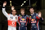 MELBOURNE, AUSTRALIA - MARCH 26:  Pole sitter Sebastian Vettel (C) of Germany and Red Bull Racing celebrates in parc ferme with second placed Lewis Hamilton (L) of Great Britain and McLaren and third placed Mark Webber (R) of Australia and Red Bull Racing following qualifying for the Australian Formula One Grand Prix at the Albert Park Circuit on March 26, 2011 in Melbourne, Australia.  (Photo by Paul Gilham/Getty Images)