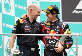 KUALA LUMPUR, MALAYSIA - APRIL 10:  Sebastian Vettel (R) of Germany and Red Bull Racing celebrates with Red Bull Racing Chief Technical Officer Adrian Newey on the podium after winning the Malaysian Formula One Grand Prix at the Sepang Circuit on April 10, 2011 in Kuala Lumpur, Malaysia.  (Photo by Paul Gilham/Getty Images)