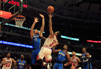 CHICAGO, IL - JANUARY 28: Derrick Rose #1 of the Chicago Bulls puts up a shot between Hedo Turkoglu #15 and Gilbert Arenas #1 of the Orlando Magic at the United Center on January 28, 2011 in Chicago, Illinois. The Bulls defeated the Magic 99-90. NOTE TO USER: User expressly acknowledges and agrees that, by downloading and/or using this photograph, User is consenting to the terms and conditions of the Getty Images License Agreement. (Photo by Jonathan Daniel/Getty Images)