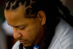ST. LOUIS - JULY 18: Manny Ramirez #99 of the Los Angeles Dodgers sits in the dugout against the St. Louis Cardinals at Busch Stadium on July 18, 2010 in St. Louis, Missouri.  (Photo by Dilip Vishwanat/Getty Images)