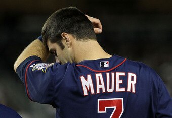 NEW YORK - OCTOBER 09:  Joe Mauer #7 of the Minnesota Twins wipes his forehead against the New York Yankees during Game Three of the ALDS part of the 2010 MLB Playoffs at Yankee Stadium on October 9, 2010 in the Bronx borough of New York City.  (Photo by Jim McIsaac/Getty Images)