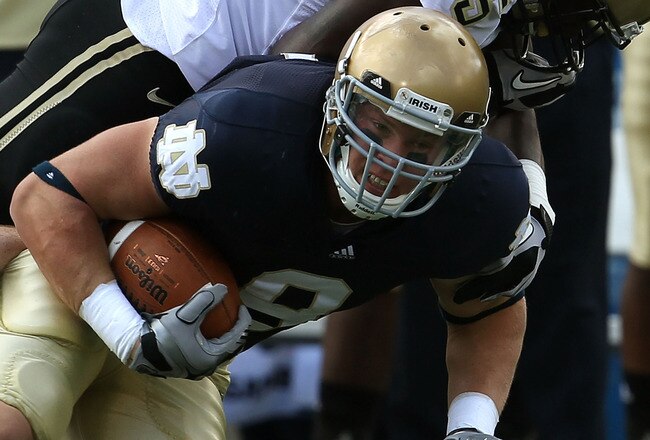 SOUTH BEND, IN - SEPTEMBER 04: Kyle Rudolph #9 of the Notre Dame Fighting Irish is tackled by Charlton Williams #15 of the Purdue Boilermakers at Notre Dame Stadium on September 4, 2010 in South Bend, Indiana. Notre Dame defeated Purdue 23-12. (Photo by Jonathan Daniel/Getty Images)