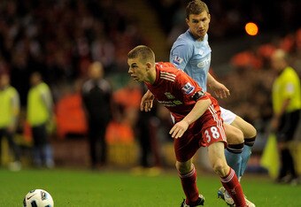 LIVERPOOL, ENGLAND - APRIL 11:   John Flanagan of Liverpool competes with Edin Dzeko of Manchester City during the Barclays Premier League match between Liverpool and Manchester City at Anfield on April 11, 2011 in Liverpool, England. (Photo by Michael Regan/Getty Images)