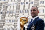 MUMBAI, INDIA - APRIL 03:  India's cricket team captain Mahendra Singh Dhoni poses with the  ICC Cricket World Cup Trophy during a photo call  at the Taj Palace Hotel on April 3, 2011 in Mumbai, India.  (Photo by Ritam Banerjee/Getty Images)
