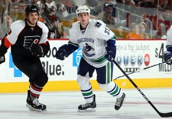 PHILADELPHIA - DECEMBER 03:  Rick Rypien #37 of the Vancouver Canucks skates against Dan Carcillo #13 of the Philadelphia Flyers on December 3, 2009 at Wachovia Center in Philadelphia, Pennsylvania. The Canucks defeated the Flyers 3-0.  (Photo by Jim McIsaac/Getty Images)