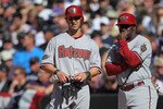 DENVER, CO - APRIL 01:  Firstbase coach Eric Young  of the Arizona Diamondbacks directs Willie Bloomquist #18 of the Arizona Diamondbacks against the Colorado Rockies during Opening Day at Coors Field on April 1, 2011 in Denver, Colorado. The Diamondbacks defeated the Rockies 7-6 in 11 innings.  (Photo by Doug Pensinger/Getty Images)