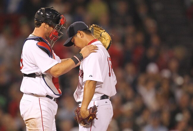 BOSTON, MA - APRIL 11:  Jarrod Saltalamacchia #39 consoles Daisuke Matsuzaka #18 of the Boston Red Sox after a six-run second inning against the Tampa Bay Rays at Fenway Park April 11, 2011 in Boston, Massachusetts. (Photo by Jim Rogash/Getty Images)