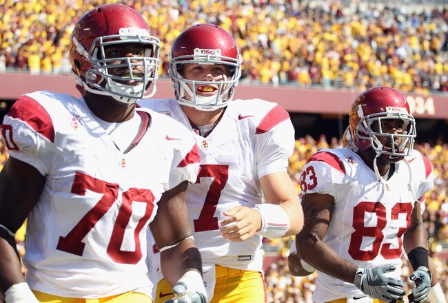 MINNEAPOLIS - SEPTEMBER 18:  Quarterback Matt Barkley #7 of the USC Trojans, flanked by Tyron Smith #70 and Ronald Johnson #83, runs off the field after the Trojans scored a touchdown during the first half of the game against the Minnesota Golden Gophers on September 18, 2010 at TCF Bank Stadium in Minneapolis, Minnesota.  (Photo by Jamie Squire/Getty Images)