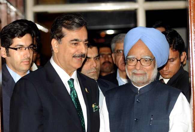 MOHALI, INDIA - MARCH 30:  Indian Prime Minister Manmohan Singh (R) and Pakistan Prime Minister Yousuf Raza Gilani (C) arrive for a dinner hosted by the Indian Prime Minister on the sidelines of the 2011 ICC World Cup second Semi-Final between India and Pakistan at Punjab Cricket Association (PCA) Stadium on March 30, 2011 in Mohali, India.  (Photo by Raveendran-Pool/Getty Images)