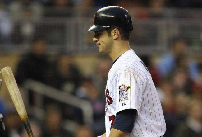 MINNEAPOLIS, MN - APRIL 9: Joe Mauer #7 of the Minnesota Twins reacts after a called strike three in the fifth inning against the Oakland Athletics on April 9, 2011 at Target Field in Minneapolis, Minnesota. Athletics defeated the Twins 1-0. (Photo by Hannah Foslien/Getty Images)