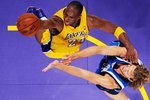 LOS ANGELES, CA - OCTOBER 30: Kobe Bryant #24 of the Los Angeles Lakers glides to the basket against Dirk Nowitzki #41 of the Dallas Mavericks during the NBA basketball game at Staples Center on October 30, 2009 in Los Angeles, California.  NOTE TO USER: User expressly acknowledges and agrees that, by downloading and/or using this Photograph, user is consenting to the terms and conditions of the Getty Images License Agreement.  (Photo by Kevork Djansezian/Getty Images)