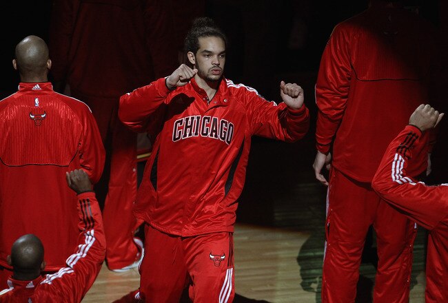 CHICAGO, IL - APRIL 13: Joakim Noah #13 of the Chicago Bulls is greeted by teammates during player introductions before a game against the New Jersey Nets at the United Center on April 13, 2011 in Chicago, Illinois. The Bulls defeated the Nets 97-92. NOTE TO USER: User expressly acknowledges and agress that, by downloading and/or using this photograph, User is consenting to the terms and conditions of the Getty Images License Agreement.  (Photo by Jonathan Daniel/Getty Images)