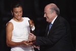 ZURICH, SWITZERLAND - JANUARY 10:  Marta (l) of Brazil winner of the women's player of the year receives her award from Fifa President Sepp Blatter (r) during the FIFA Ballon d'or Gala at the Zurich Kongresshaus on January 10, 2011 in Zurich, Switzerland.  (Photo by Michael Steele/Getty Images)