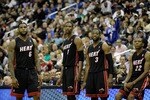 WASHINGTON, DC - MARCH 30:  LeBron James #6 of the Miami Heat stands with teammates Chris Bosh #1,  Dwyane Wade #3, and James Jones #22 against the Washington Wizards at the Verizon Center on March 30, 2011 in Washington, DC. NOTE TO USER: User expressly acknowledges and agrees that, by downloading and/or using this Photograph, User is consenting to the terms and conditions of the Getty Images License Agreement.  (Photo by Rob Carr/Getty Images)