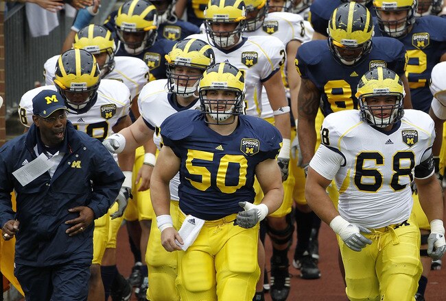 ANN ARBOR, MI - APRIL 16:  David Molk #50 and Mike Martin #68 of the Michigan Wolverines lead their team onto the field prior to the start of the annual Spring Game at Michigan Stadium on April 16, 2011 in Ann Arbor, Michigan.  (Photo by Leon Halip/Getty Images)