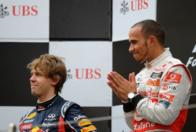 SHANGHAI, CHINA - APRIL 17:  Race winner Lewis Hamilton (L) of Great Britain and McLaren celebrates on the podium with second placed Sebastian Vettel (R) of Germany and Red Bull Racing following the Chinese Formula One Grand Prix at the Shanghai International Circuit on April 17, 2011 in Shanghai, China.  (Photo by Clive Mason/Getty Images)
