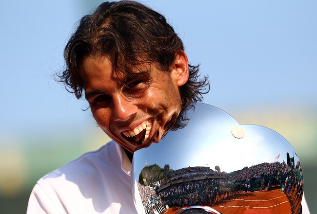 MONACO - APRIL 17:  Rafael Nadal of Spain bites the trophy as he celebrates defeating David Ferrer of Spain in the final during Day Eight of the ATP Masters Series Tennis at the Monte Carlo Country Club on April 17, 2011 in Monte Carlo, Monaco.  (Photo by Julian Finney/Getty Images)
