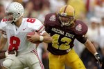 1 Jan 1997:  Quarterback Stanley Jackson of the Ohio State Buckeyes   moves the ball as Arizona State Sun Devils linebacker Pat Tillman chases him during the Rose Bowl at the Rose Bowl in Pasadena, California.  Ohio State won the game, 20-17. Mandatory Cr