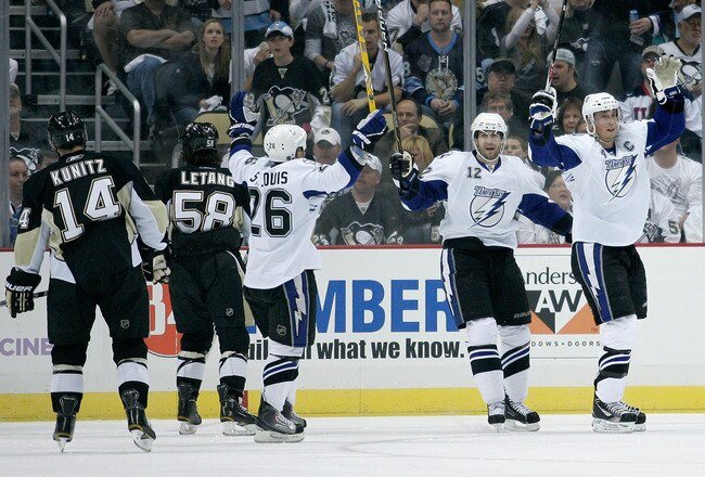 PITTSBURGH, PA - APRIL 15:  Vincent Lecavalier#4 (R) of the Tampa Bay Lightning celebrates his first period goal with his teammates during Game Two of the Eastern Conference Quarterfinals against the  Pittsburgh Penguins during the 2011 NHL Stanley Cup Playoffs at Consol Energy Center on April 15, 2011 in Pittsburgh, Pennsylvania.  (Photo by Justin K. Aller/Getty Images)