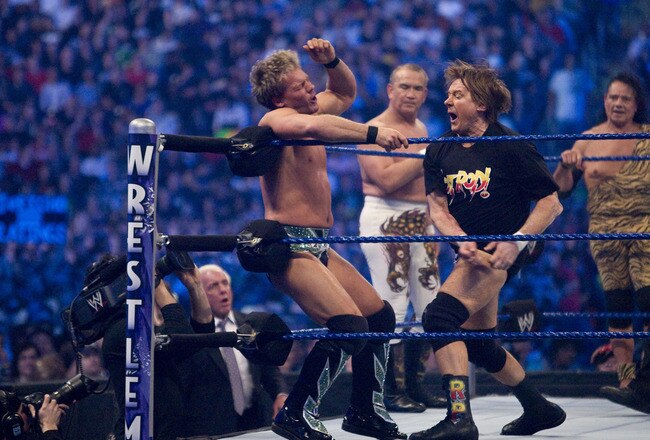 HOUSTON, TX - APRIL 5:  (L-R) Former professional wrestlers Ric Flair (seen outside the ring) looks on as WWE Superstar Chris Jericho gets pummeled on the ropes by 'Rowdy' Roddy Piper. Ricky 'The Dragon' Steamboat and Jimmy 'Superfly' Snuka look on during  WrestleMania 25 at Reliant Stadium on April 5, 2009 in Houston, Texas.  (Photo by Bill Olive/Getty Images)