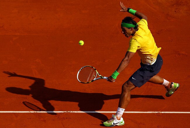 MONACO - APRIL 17:  Rafael Nadal of Spain plays a volley to David Ferrer of Spain in the final during Day Eight of the ATP Masters Series Tennis at the Monte Carlo Country Club on April 17, 2011 in Monte Carlo, Monaco.  (Photo by Julian Finney/Getty Images)