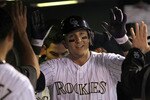 DENVER, CO - APRIL 05:  Troy Tulowitzki #2 of the Colorado Rockies is congratulated in the dugout after his solo homerun off of starting pitcher Clayton Kershaw of the Los Angeles Dodgers to give the Rockies a 1-0 lead in the fourth inning at Coors Field on April 5, 2011 in Denver, Colorado.  (Photo by Doug Pensinger/Getty Images)