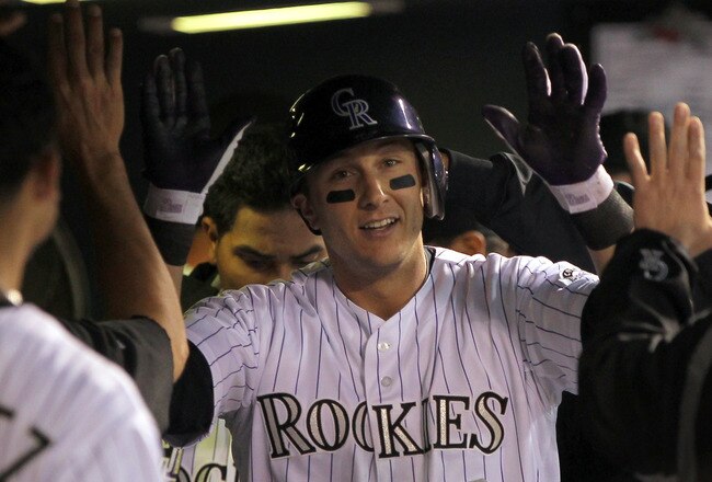 DENVER, CO - APRIL 05:  Troy Tulowitzki #2 of the Colorado Rockies is congratulated in the dugout after his solo homerun off of starting pitcher Clayton Kershaw of the Los Angeles Dodgers to give the Rockies a 1-0 lead in the fourth inning at Coors Field on April 5, 2011 in Denver, Colorado.  (Photo by Doug Pensinger/Getty Images)