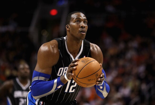 PHOENIX, AZ - MARCH 13:  Dwight Howard #12 of the Orlando Magic shoots a free throw shot during the NBA game against the Phoenix Suns at US Airways Center on March 13, 2011 in Phoenix, Arizona. The Magic defeated the Suns 111-88. NOTE TO USER: User expressly acknowledges and agrees that, by downloading and or using this photograph, User is consenting to the terms and conditions of the Getty Images License Agreement.  (Photo by Christian Petersen/Getty Images)