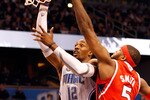 ORLANDO, FL - APRIL 16:  Dwight Howard #12 of the Orlando Magic shoots over Josh Smith #5 of the Atlanta Hawks during Game One of the Eastern Conference Quarterfinals of the 2011 NBA Playoffs on April 16, 2011 at the Amway Arena in Orlando, Florida.  NOTE TO USER: User expressly acknowledges and agrees that, by downloading and/or using this Photograph, user is consenting to the terms and conditions of the Getty Images License Agreement.  (Photo by J. Meric/Getty Images)