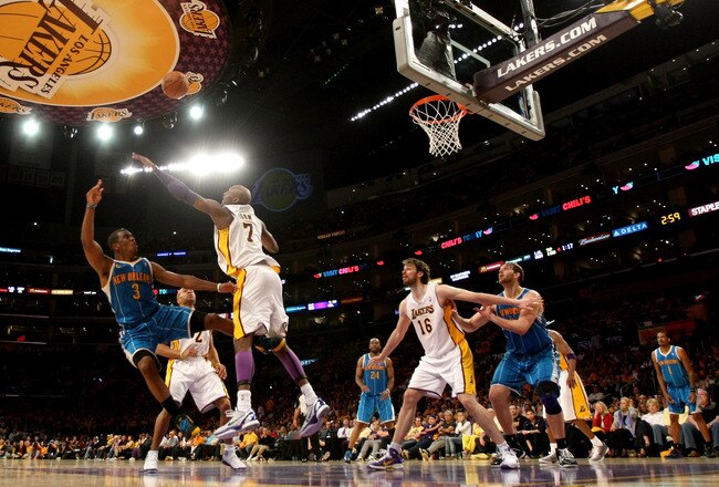 LOS ANGELES, CA - APRIL 17:  Chris Paul #3 of the New Orleans Hornets shoots over Lamar Odom #7 of the Los Angeles Lakers as Laker Pau Gasol #16 and Hornet Aaron Gray #34 look for a rebound in Game One of the Western Conference Quarterfinals in the 2011 NBA Playoffs on April 17, 2011 at Staples Center in Los Angeles, California. The Hornets won 109-101. NOTE TO USER: User expressly acknowledges and agrees that, by downloading and or using this photograph, User is consenting to the terms and conditions of the Getty Images License Agreement. (Photo by Stephen Dunn/Getty Images)