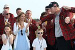HILTON HEAD ISLAND, SC - APRIL 18:  Jim Furyk is fitted with the winner's jacket and celebrates with his wife Tabitha (C) son Tanner (R) and daughter Caleigh (L) after winning the 2010 Verizon Heritage at the Harbour Town Golf Links on April 18, 2010 in Hilton Head lsland, South Carolina.  (Photo by Scott Halleran/Getty Images)