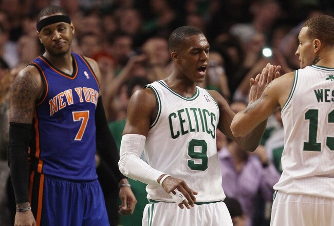 BOSTON, MA - APRIL 19:  Rajon Rondo #9 of the Boston Celtics congratulates Delonte West #13 after he made a free throw with .6 seconds left in the game as Carmelo Anthony #7 of the New York Knicks reacts in Game Two of the Eastern Conference Quarterfinals in the 2011 NBA Playoffs on April 19, 2011 at the TD Garden in Boston, Massachusetts. The Boston Celtics defeated the New York Knicks 96-93. NOTE TO USER: User expressly acknowledges and agrees that, by downloading and or using this photograph, User is consenting to the terms and conditions of the Getty Images License Agreement.  (Photo by Elsa/Getty Images)
