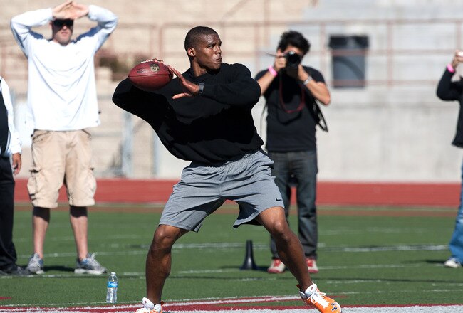 SAN DIEGO, CA - FEBRUARY 10: 2010 Heisman Trophy winning quarterback Cam Newton of Auburn throws the ball during his workout routine for the media at Cathedral High School's sports stadium on February 10, 2011 in San Diego, California. (Photo by Kent Horner/ Getty Images)